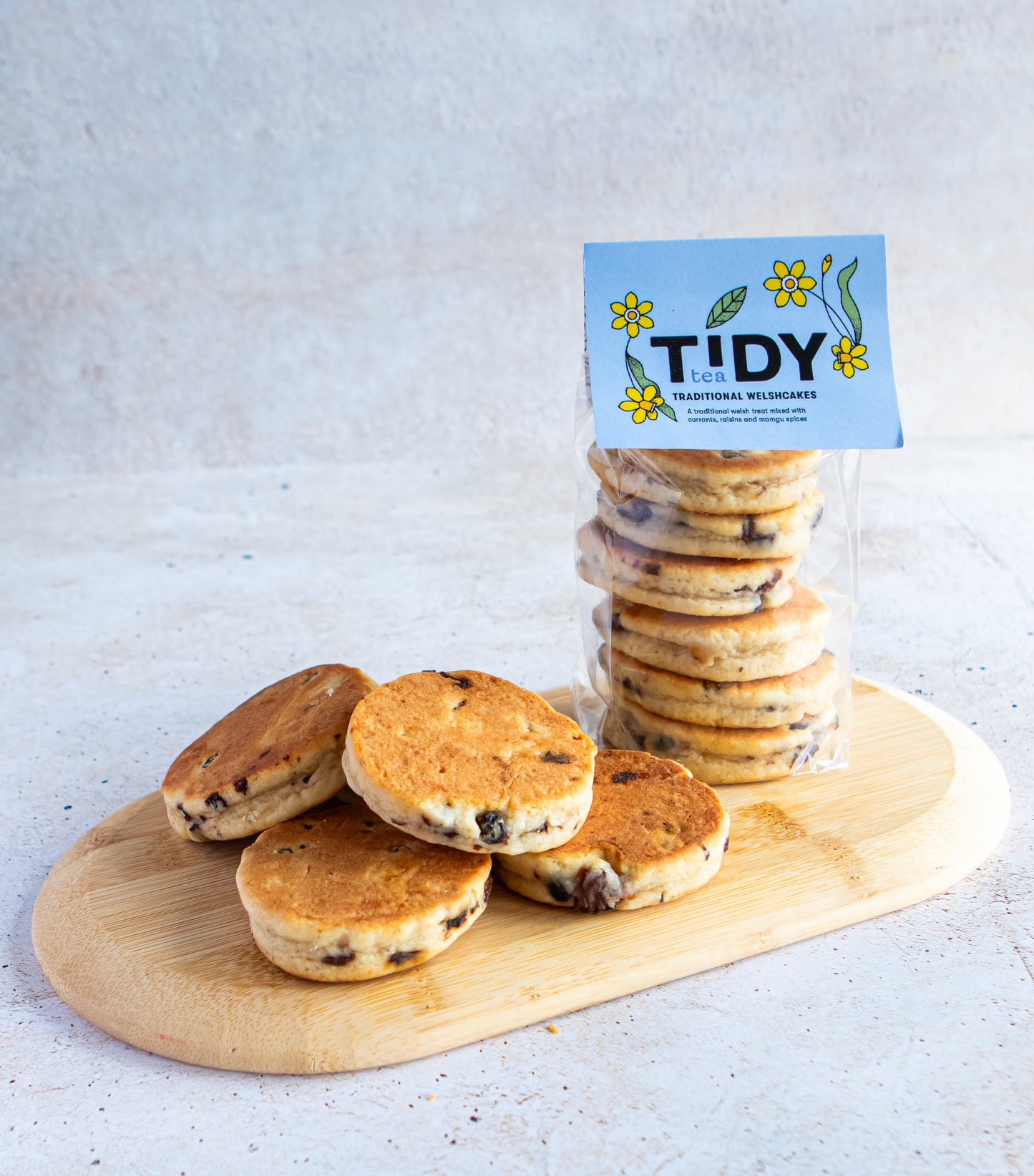 A stack of welsh tea cakes on a chopping board